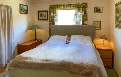a bedroom with a large bed and a window at 4 Bedroom Gorgeous Home In Valldal in Valldal
