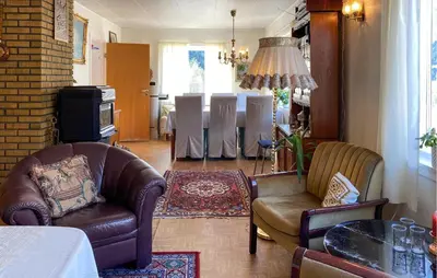 a living room with two leather chairs and a table at 4 Bedroom Gorgeous Home In Valldal in Valldal