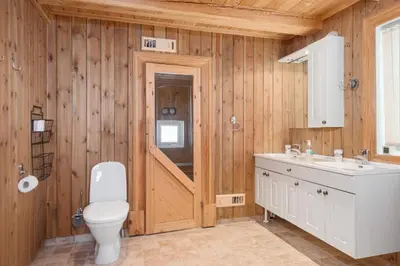 a wooden bathroom with a toilet and a sink at Trysilfjell sør 825 in Trysil