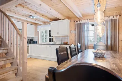 a kitchen and dining room with a table and chairs at Trysilfjell sør 825 in Trysil