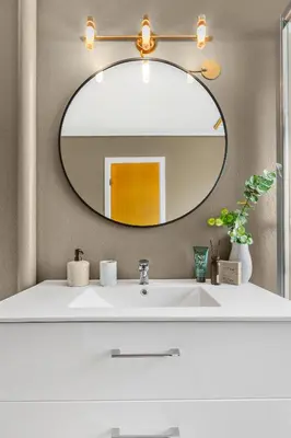 a bathroom with a white sink and a mirror at Engbu in Vågbø