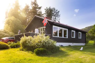 a group of people standing on the balcony of a house at Engbu in Vågbø