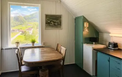a small kitchen with a table and a window at Cozy Home In Austefjorden With Wifi in Austefjorden