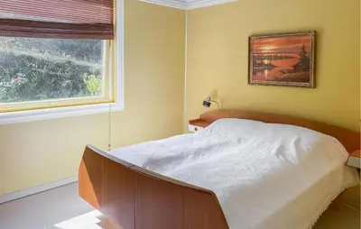 a bedroom with a bed and a window at Cozy Home In Austefjorden With Wifi in Austefjorden