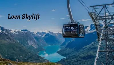 a gondola ride over a lake in the mountains at Flotun in Stryn
