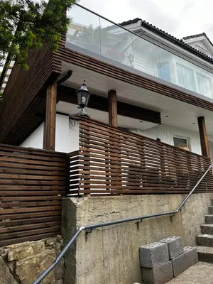 a home with a wooden fence and stairs at Apartment Lagunen with Terrace, Grill and Free Parking in Bergen