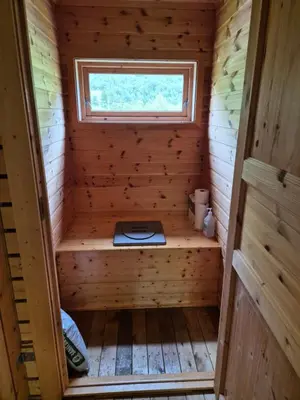 a sauna in a wooden cabin with a window at Hytta på Kvia, Rognestøyldalen - Sæbø in Sæbø