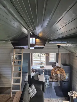 a room with a loft bed in a tiny house at Hytta på Kvia, Rognestøyldalen - Sæbø in Sæbø