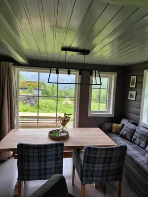 a living room with a table and a couch at Hytta på Kvia, Rognestøyldalen - Sæbø in Sæbø