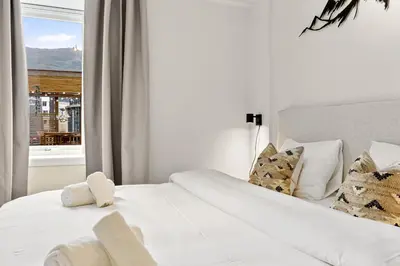 two beds in a room with a window at Pergola - Free parking - 5 min walk to facilities in Bergen