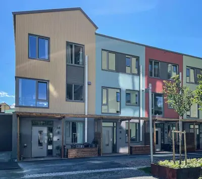 an apartment building with a lot of windows at Modern 4 bedroom townhouse with garden and indoor car park in Trondheim