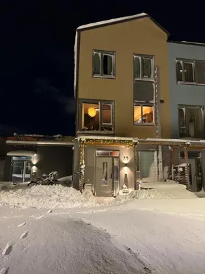 a house in the snow at night at Modern 4 bedroom townhouse with garden and indoor car park in Trondheim