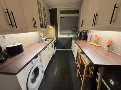 a kitchen with a washer and dryer in it at Fin leilighet nært alt in Bergen
