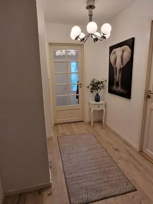 a hallway with a door with an elephant picture on the wall at Eidsvåg in Bergen