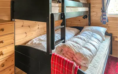 a bedroom with bunk beds in a tiny house at 3 Bedroom Stunning Home In Vossestrand in Vossestrand