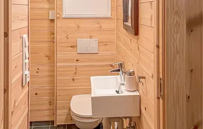 a bathroom with a toilet and a sink at 3 Bedroom Stunning Home In Vossestrand in Vossestrand