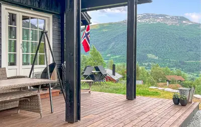a screened in porch with a view of a mountain at 3 Bedroom Stunning Home In Vossestrand in Vossestrand