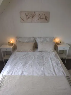 a large white bed with two nightstands and two tables at Light terrace city apartment Alesund in Ålesund