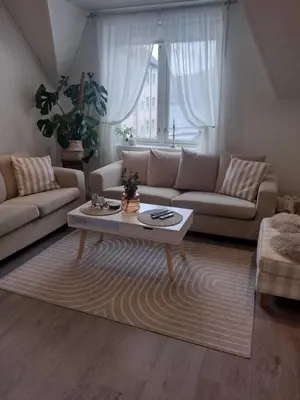 a living room with a couch and a coffee table at Light terrace city apartment Alesund in Ålesund