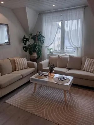 a living room with two couches and a coffee table at Light terrace city apartment Alesund in Ålesund