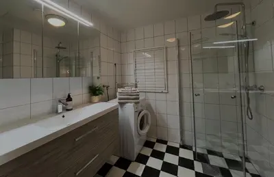 a bathroom with a shower and a toilet and a sink at Penthouse in Trondheim City Centre in Trondheim