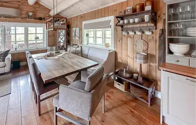 a dining room with a wooden table and chairs at 4 Bedroom Cozy Home In Gol in Golsfjellet
