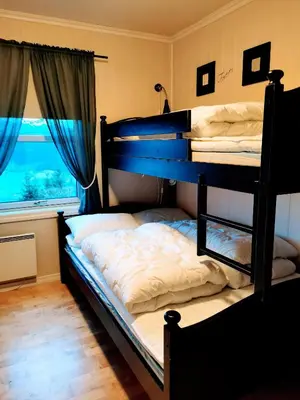 two bunk beds in a room with a window at Voss Resort self-catered apartments in Skulestadmo