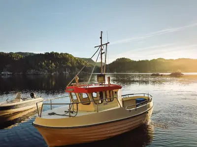 a boat sitting in the water on a lake at Holiday Home Soltun by Interhome in Flygansvær
