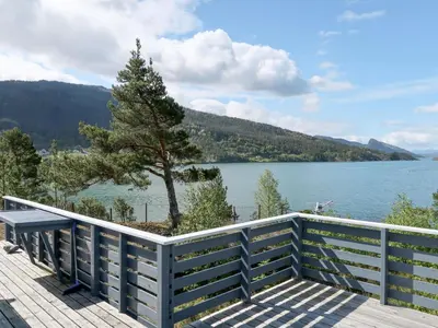 a wooden deck with a view of a lake at Holiday Home Blå Hytte by Interhome in Herand