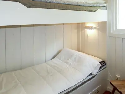 a bed in a small room with a bed under a bunk at Holiday Home Blå Hytte by Interhome in Herand