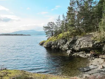 a view of a body of water with trees at Holiday Home Blå Hytte by Interhome in Herand