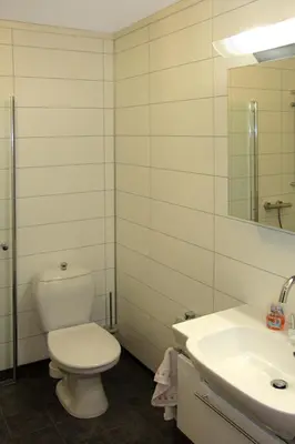 a white bathroom with a toilet and a sink at Holiday Home Hovsfjellet by Interhome in Fresvik