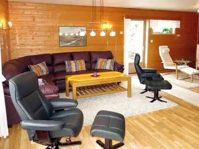 a living room with a leather couch and chairs at Holiday Home Hovsfjellet by Interhome in Fresvik