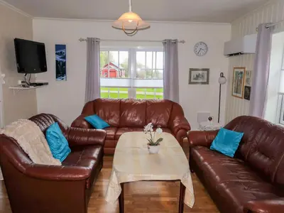 a living room with two brown leather couches and a table at Holiday Home Greenhouse by Interhome in Onarheim