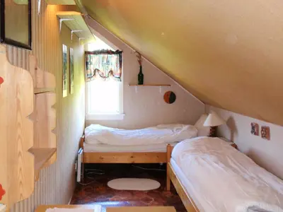 two beds in a small room with a window at Holiday Home Nystølen by Interhome in Håvik
