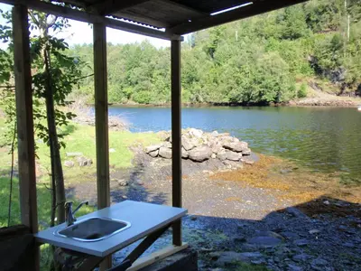 a bathroom with a sink and a view of a river at Holiday Home Nystølen by Interhome in Håvik