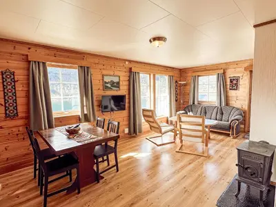 a living room with a table and chairs and a couch at Holiday Home Pærehagen by Interhome in Balestrand