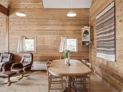 a dining room with wooden walls and a wooden table and chairs at Holiday Home Veganeset II by Interhome in Balestrand