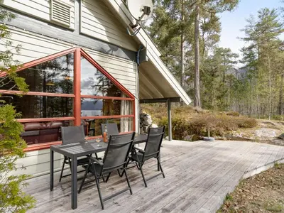 a patio with a table and chairs on a deck at Holiday Home Veganeset II by Interhome in Balestrand