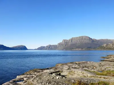 a large body of water with mountains in the background at Holiday Home Blåsenberg by Interhome in Bø
