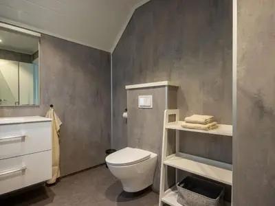a bathroom with a white toilet and a sink at Holiday Home Pale by Interhome in Bømlo