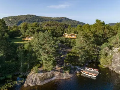 an aerial view of a house and boats in the water at Holiday Home Solbakken by Interhome in Gjølanger