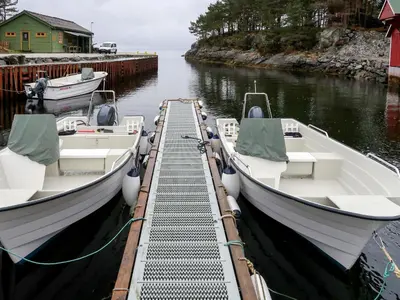 two boats docked at a dock in the water at Holiday Home Nesjevik by Interhome in Bø