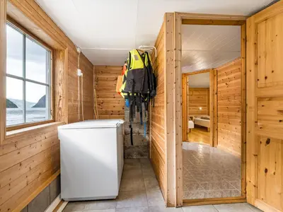 a refrigerator in a room with wooden walls at Holiday Home Balder by Interhome in Arnefjord