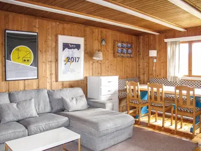 a living room with a couch and a table at Chalet Skeisvegen by Interhome in Svingvoll