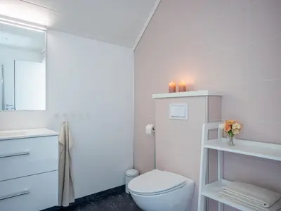 a white bathroom with a toilet and a sink at Holiday Home Lange by Interhome in Bømlo