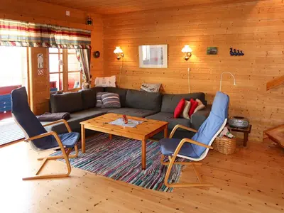 a living room with a couch and a table and chairs at Holiday Home Krokeggi by Interhome in Arnefjord