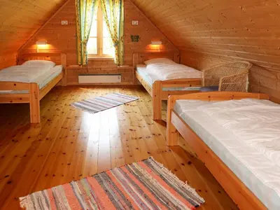 a room with three beds in a wooden cabin at Holiday Home Krokeggi by Interhome in Arnefjord
