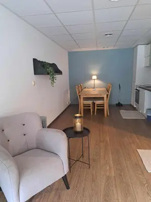 a living room with a couch and a table at Haukeli hotell leilighet in Haukeligrend