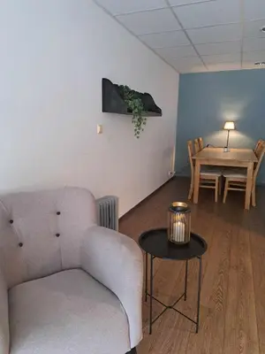 a living room with a couch and a table at Haukeli hotell leilighet in Haukeligrend